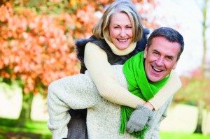 Senior man giving woman piggyback ride