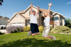 Happy Mature Couple Jumping Outside Home