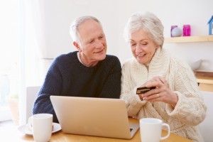 Senior Couple Using Laptop To Shop Online