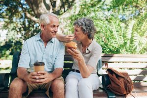 Loving senior couple sitting on a park bench