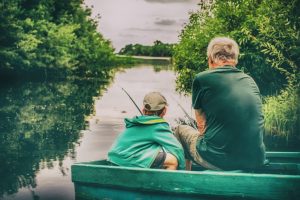 grandfather and boy fishing together